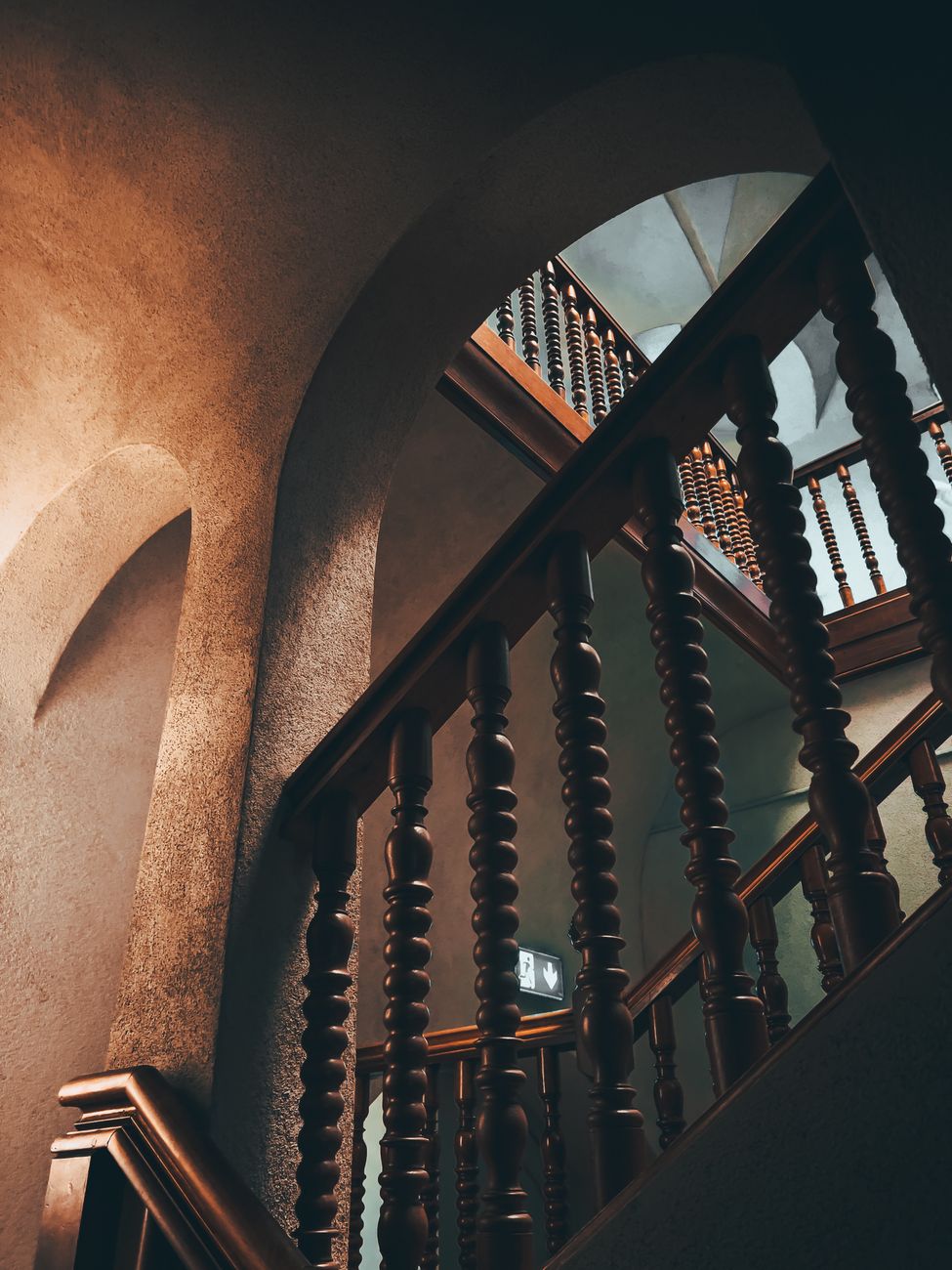 brown wooden staircase with wooden handrails