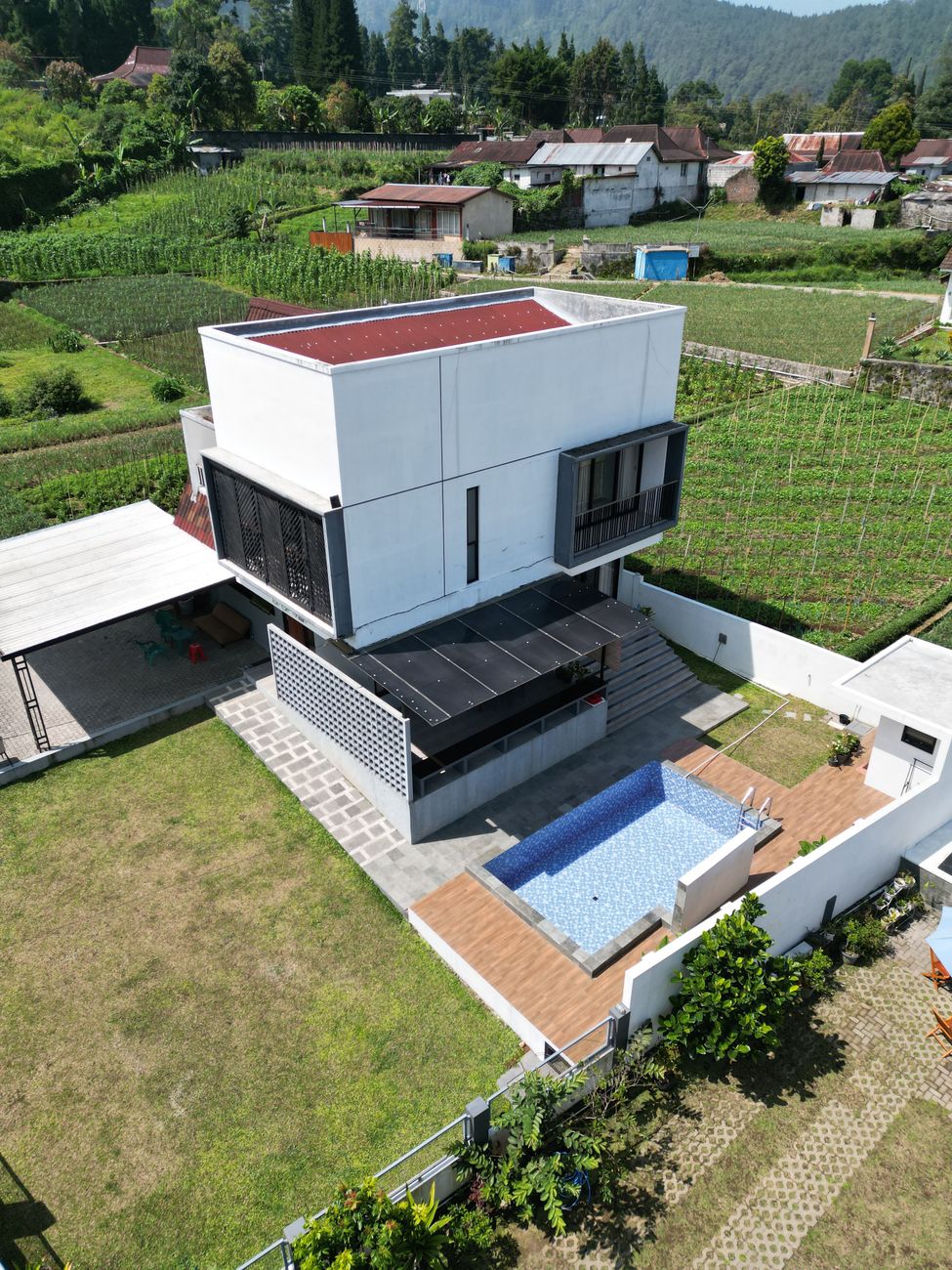 modern minimalist home with pool aerial view