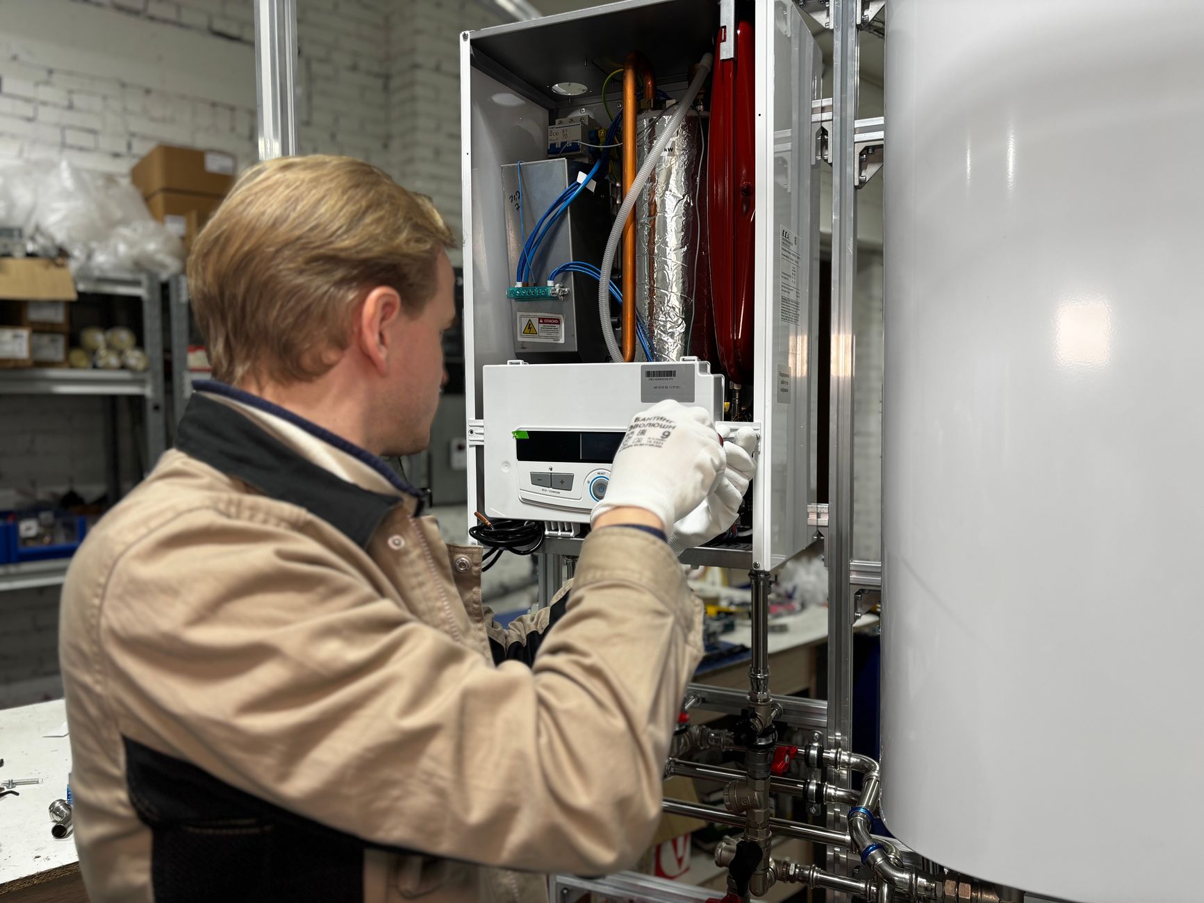 technician repairing heating system in workshop