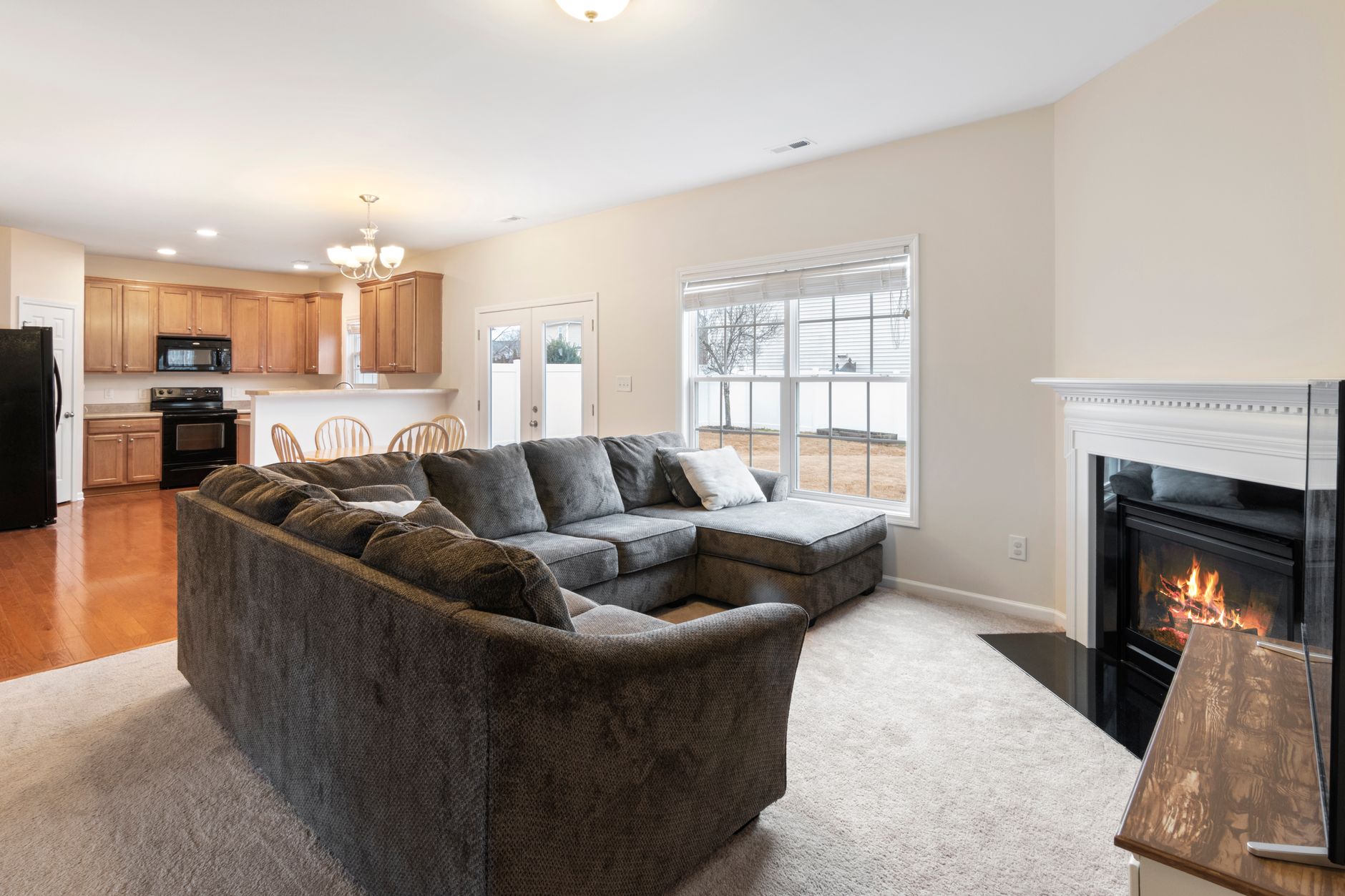 sofa and fireplace in living room with kitchenette