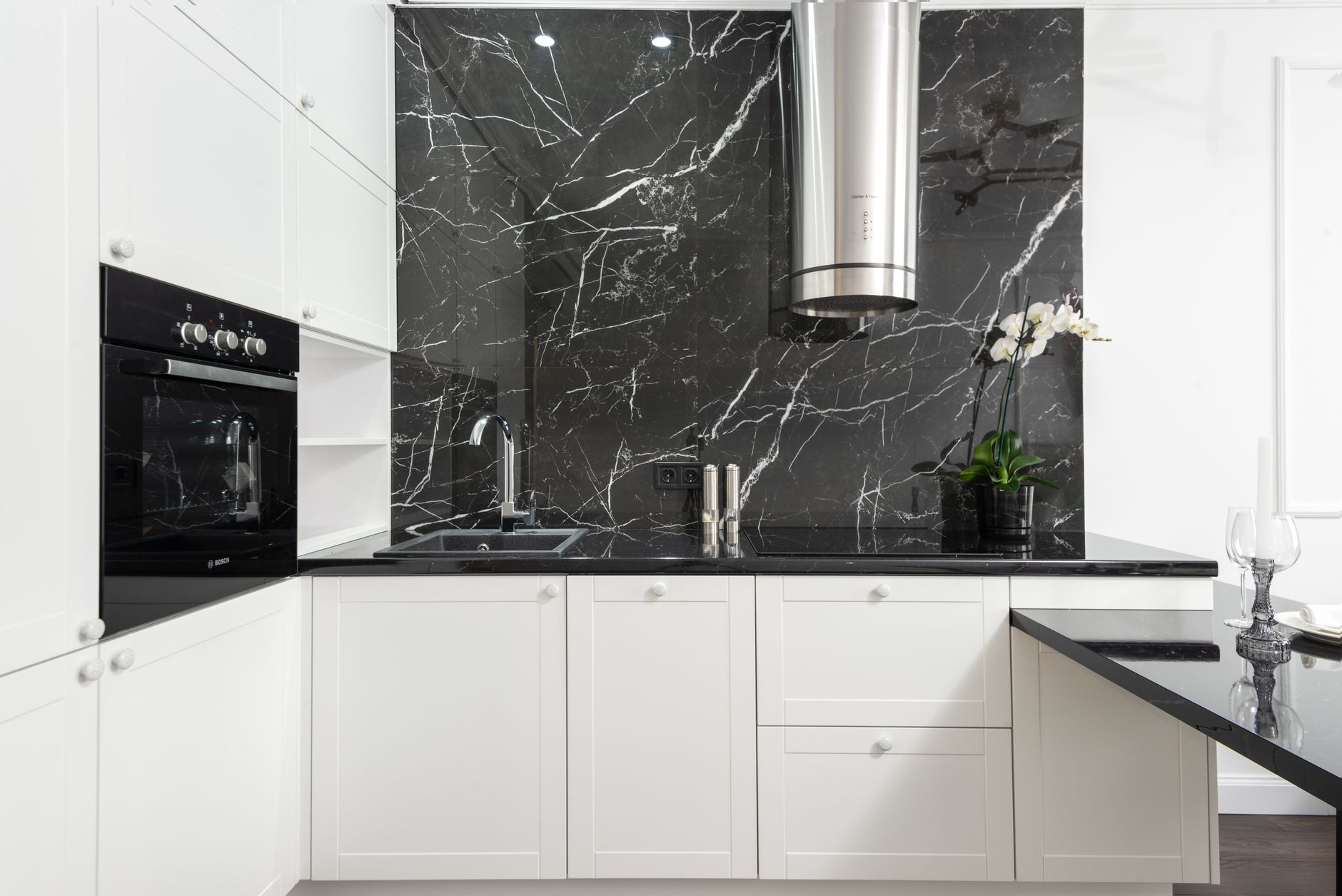 Black slate stone backsplash with matte black fixtures