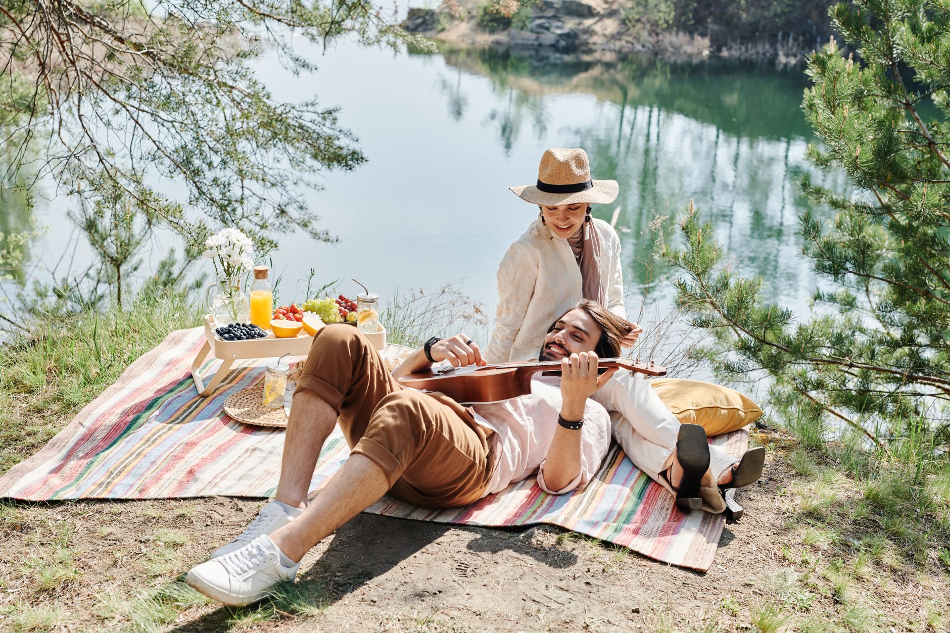 couple having a picnic near body of water