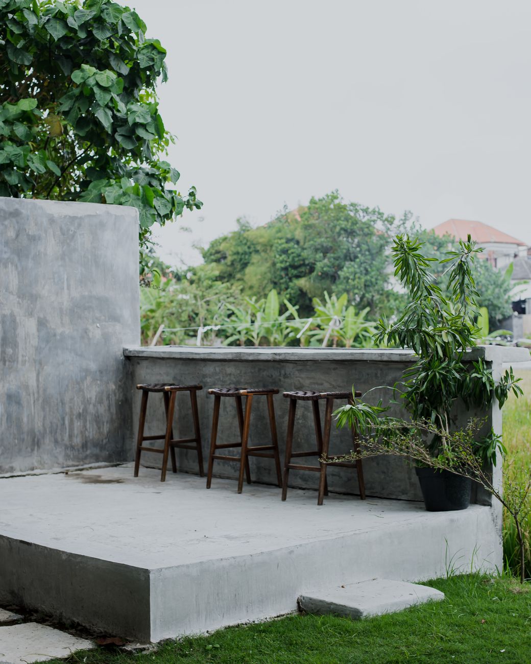high stools on a concrete patio