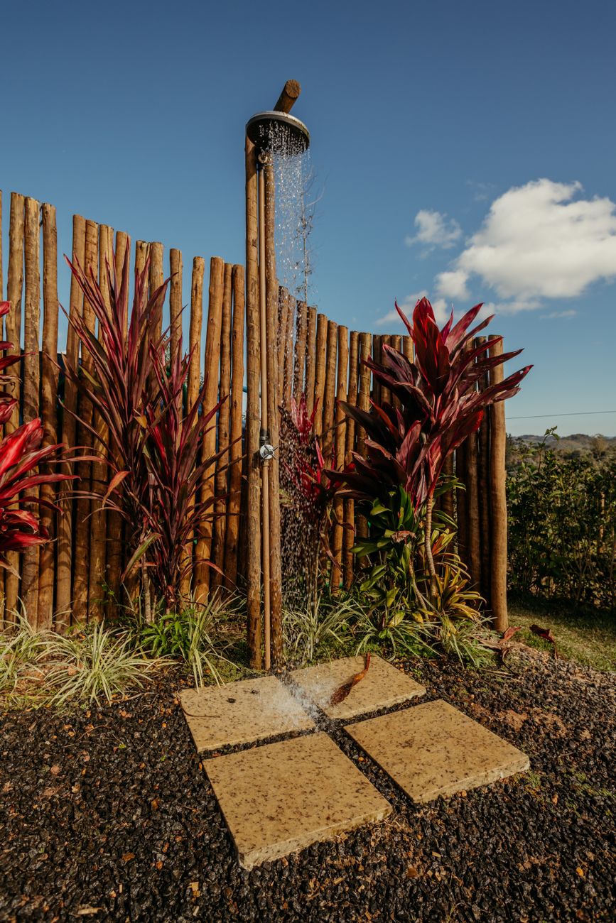partly fenced outdoor shower in the garden of cabana raposo inn