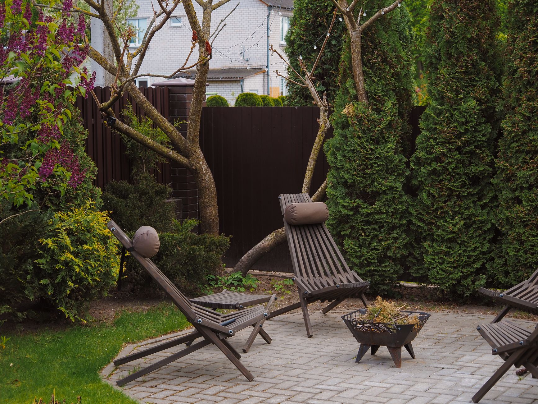 tranquil backyard with wooden lounge chairs