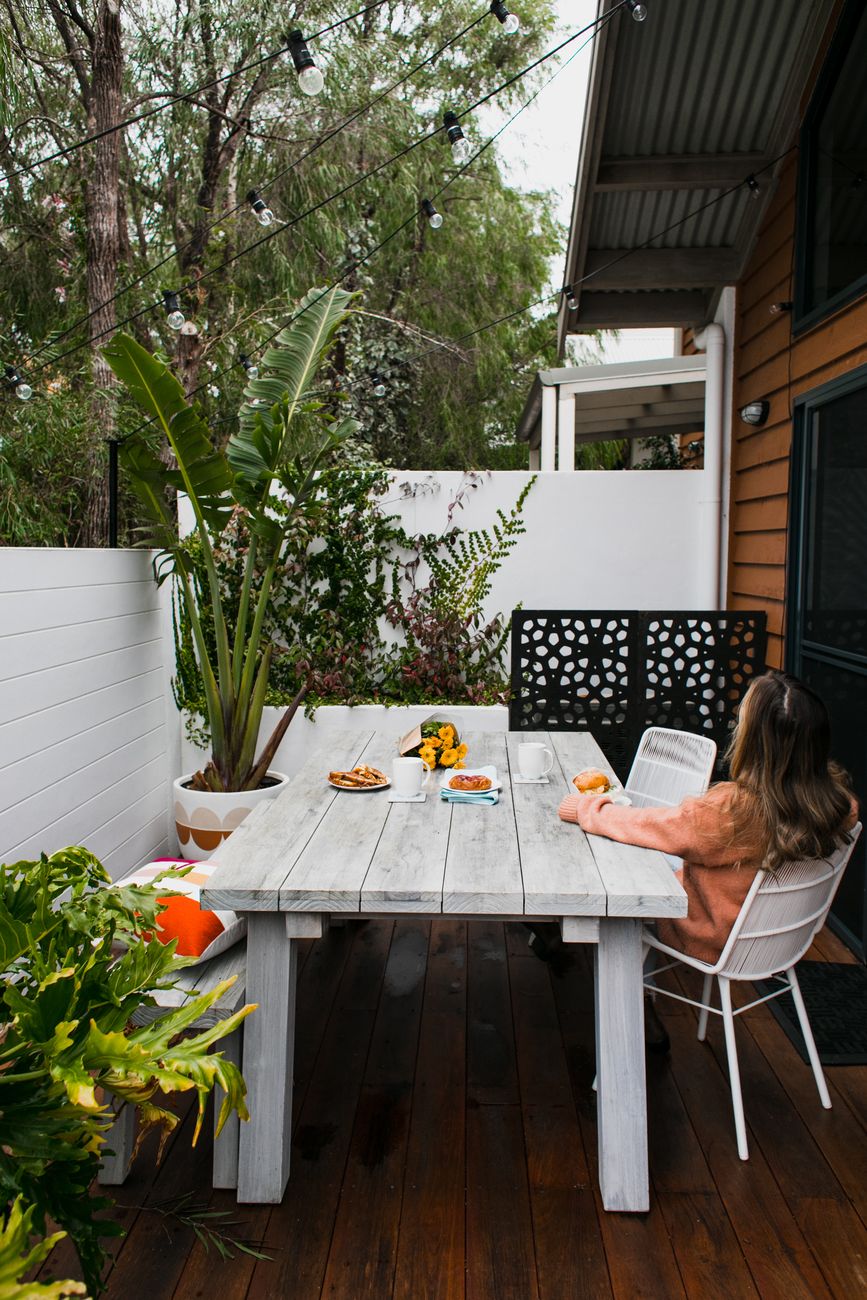 relaxed woman sitting at table on Back Porch Ideas