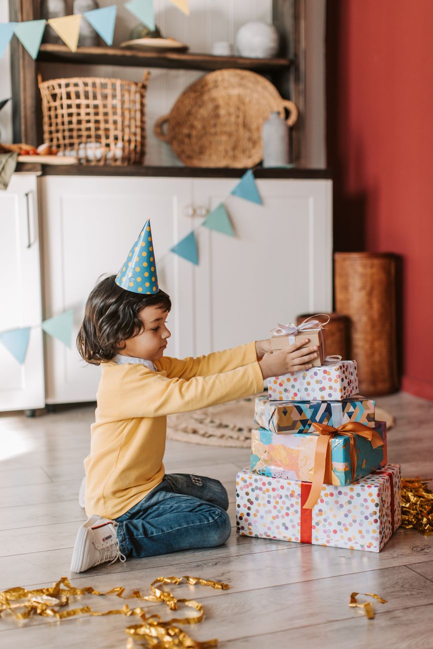 birthday girl sitting with gifts on floor