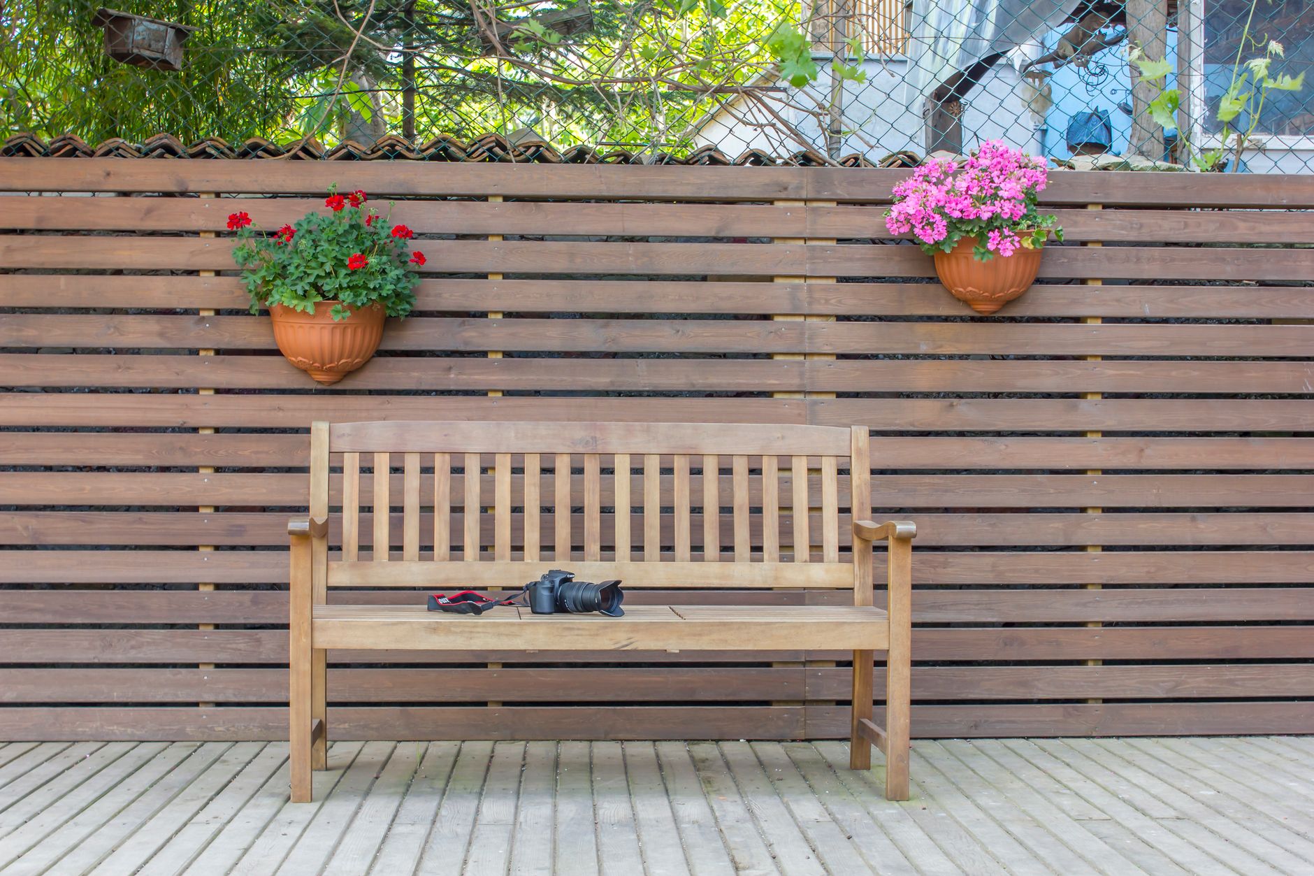 wooden bench beside brown wood fence
