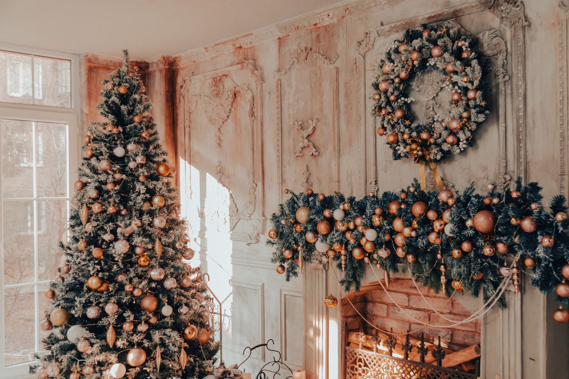 a christmas tree and wreath in front of a fireplace